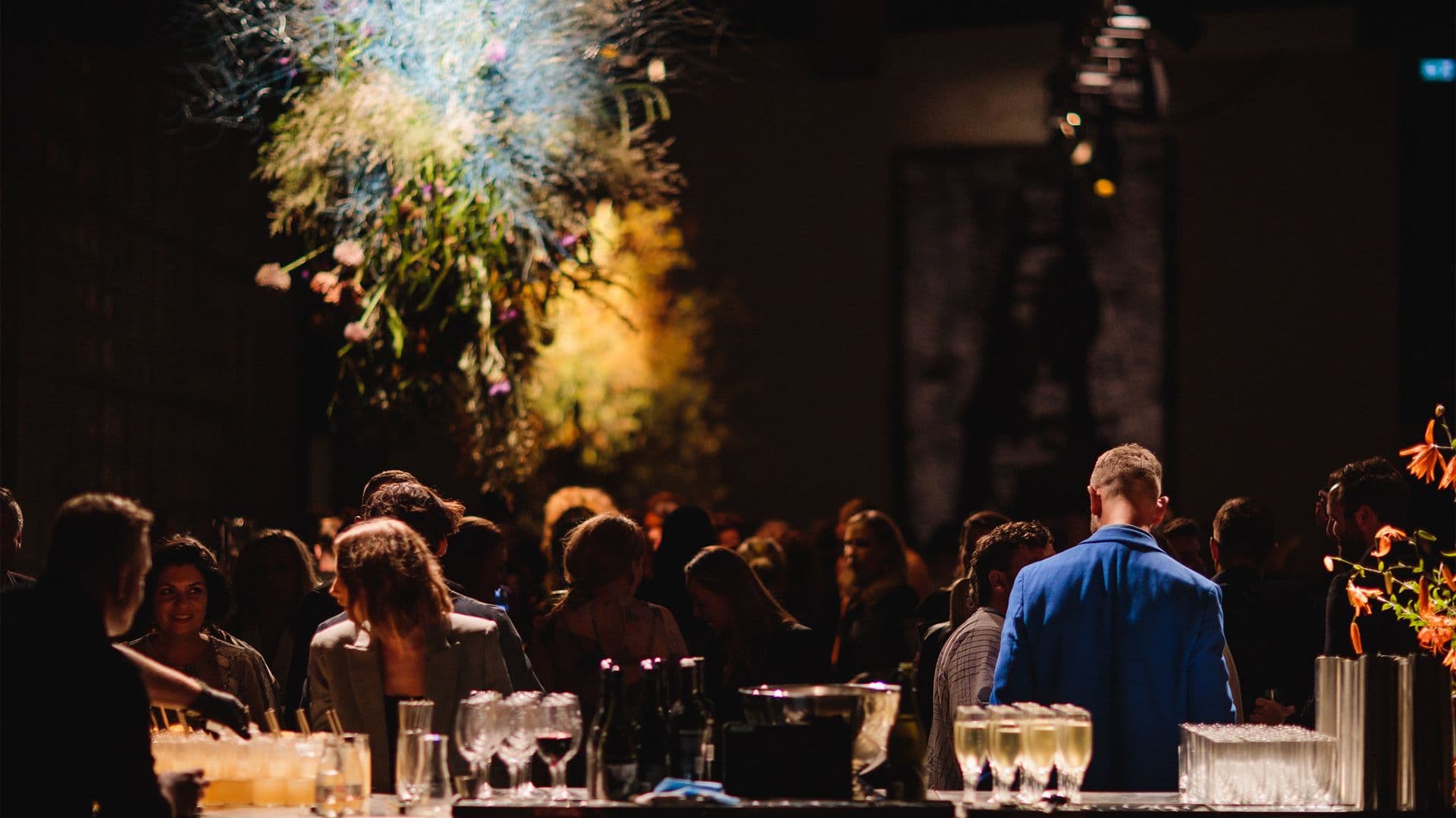 View of a crowd of people from behind the bar